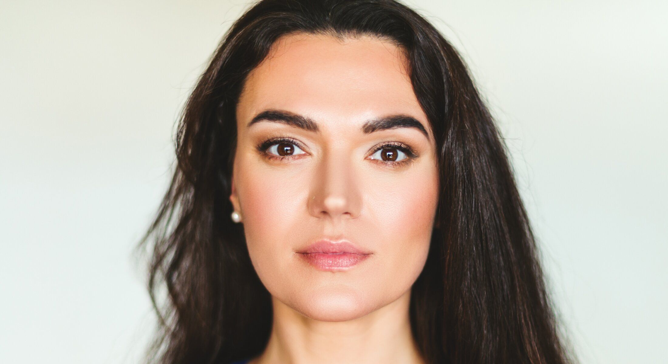 Woman with long dark hair and natural makeup