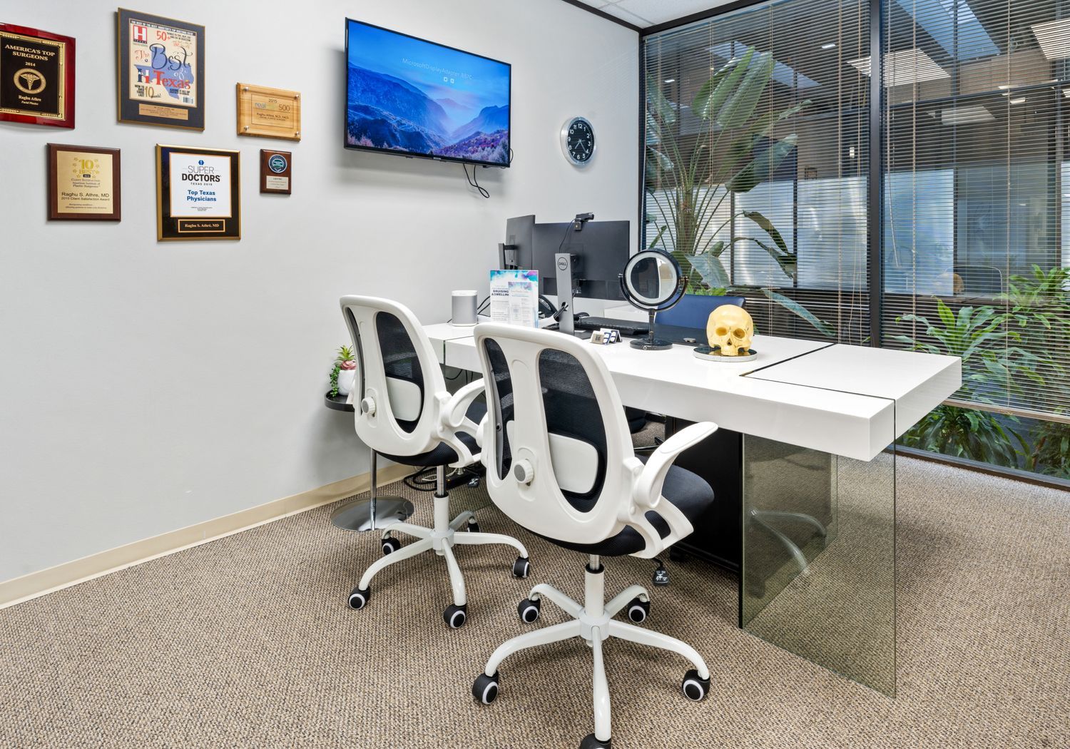 Modern office with award decorations and equipment.