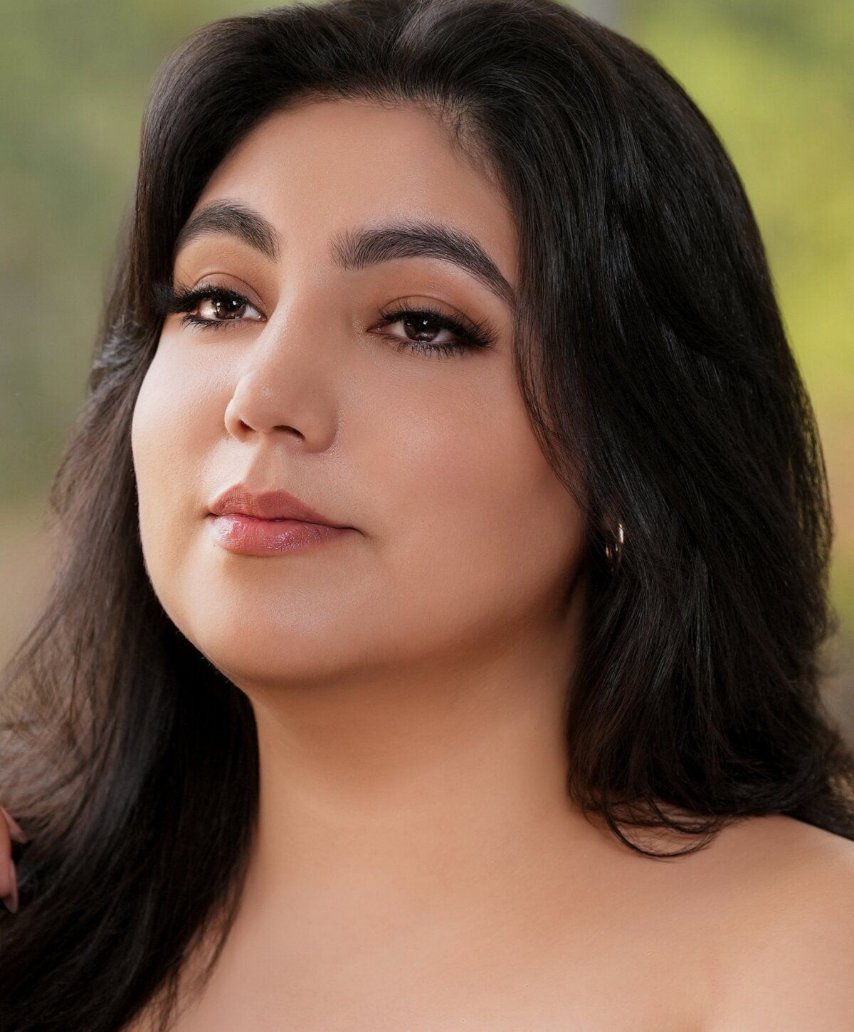 Portrait of a woman with long dark hair.