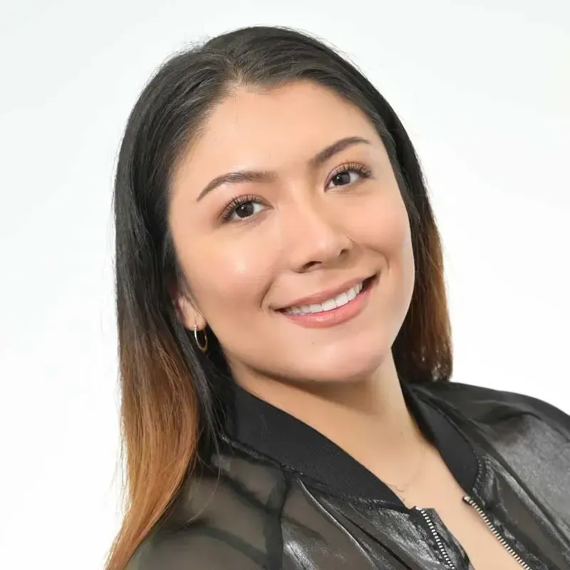 Smiling young woman in a black jacket.