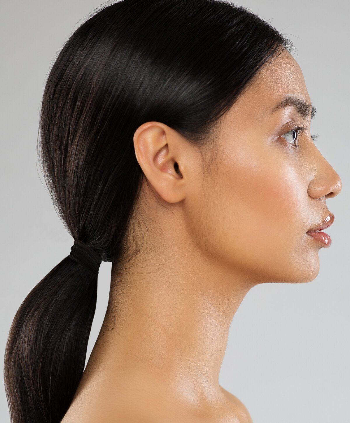 Profile of a person with sleek black hair.