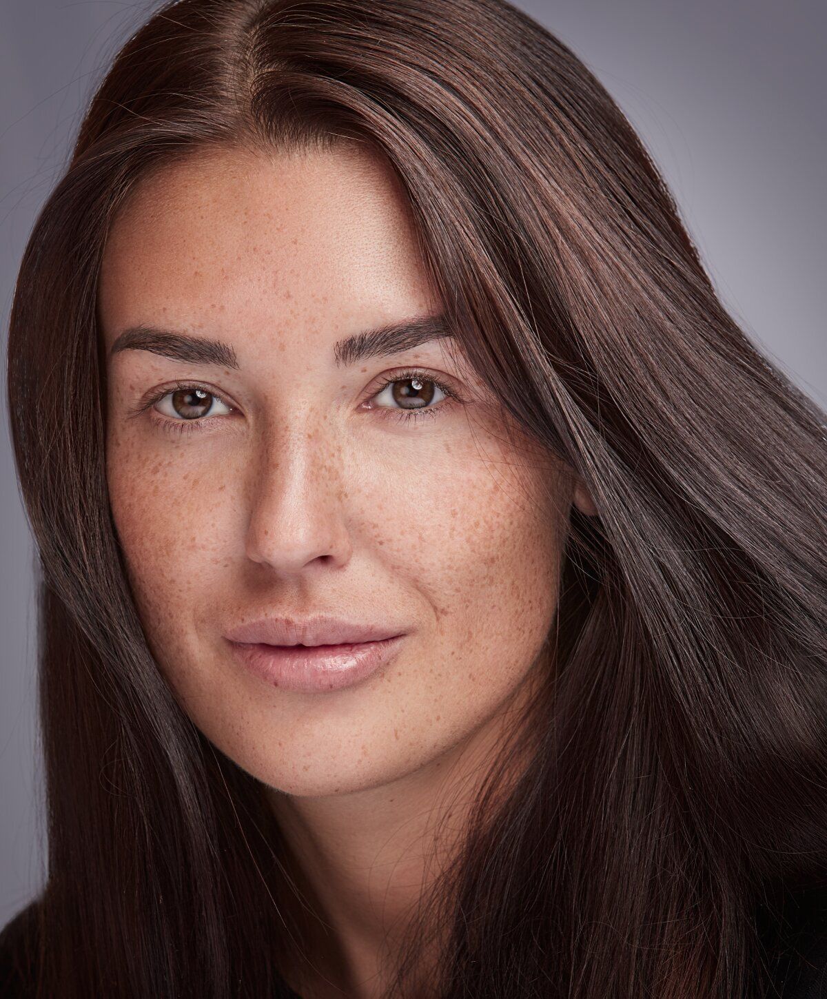 Portrait of a woman with long, dark hair.