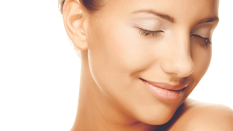 Close up portrait of woman's face smiling with clear skin