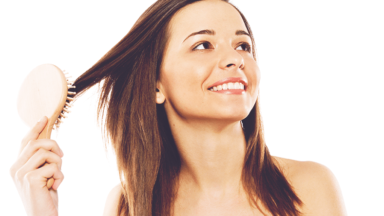 woman smiling and brushing her hair