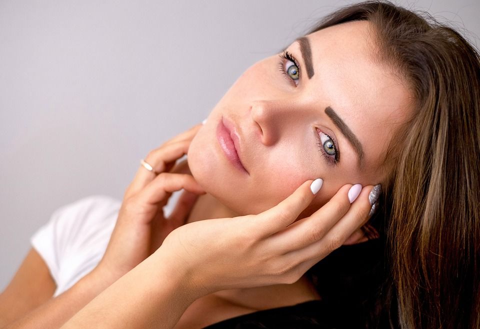 woman with clear skin looking into the camera