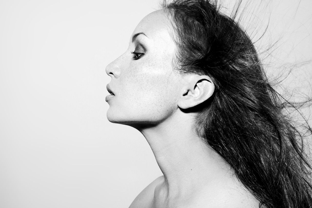 black and white image of woman's profile and clear skin